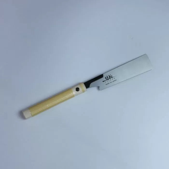 Japanese pull saw with beige handle and sharp steel blade for woodworking