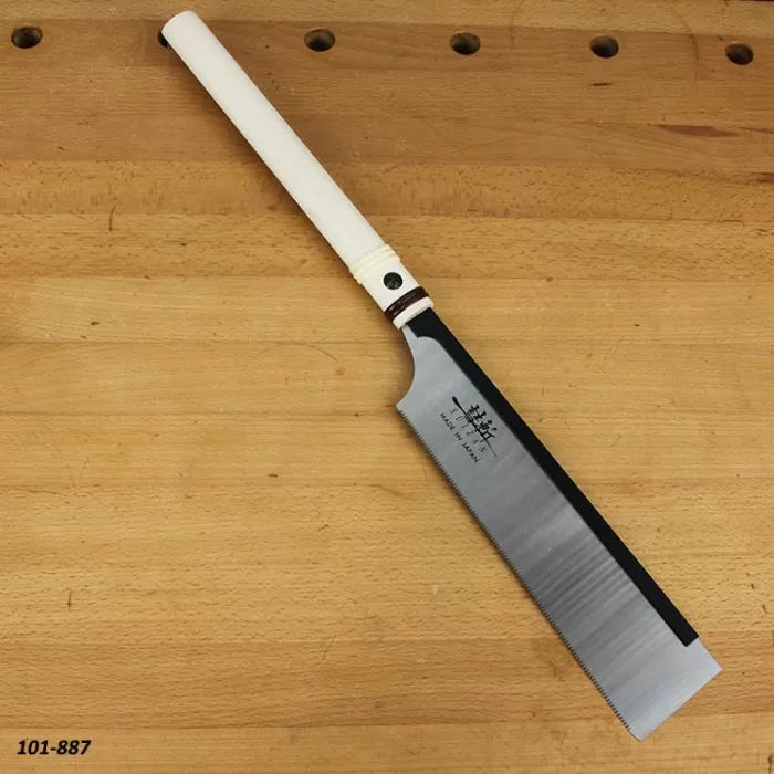 Japanese pull saw with white handle on a wooden workbench, woodworking hand tool