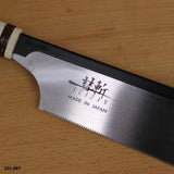 Japanese pull saw with Suizan logo on stainless steel blade, placed on a wooden surface