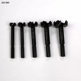 Set of five black Forstner drill bits for woodworking on white background