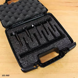 Woodworking router bit set in foam-padded carrying case on a workbench