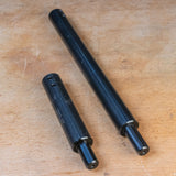 Two black steel router table extension rods on a wooden surface, woodworking tool accessory
