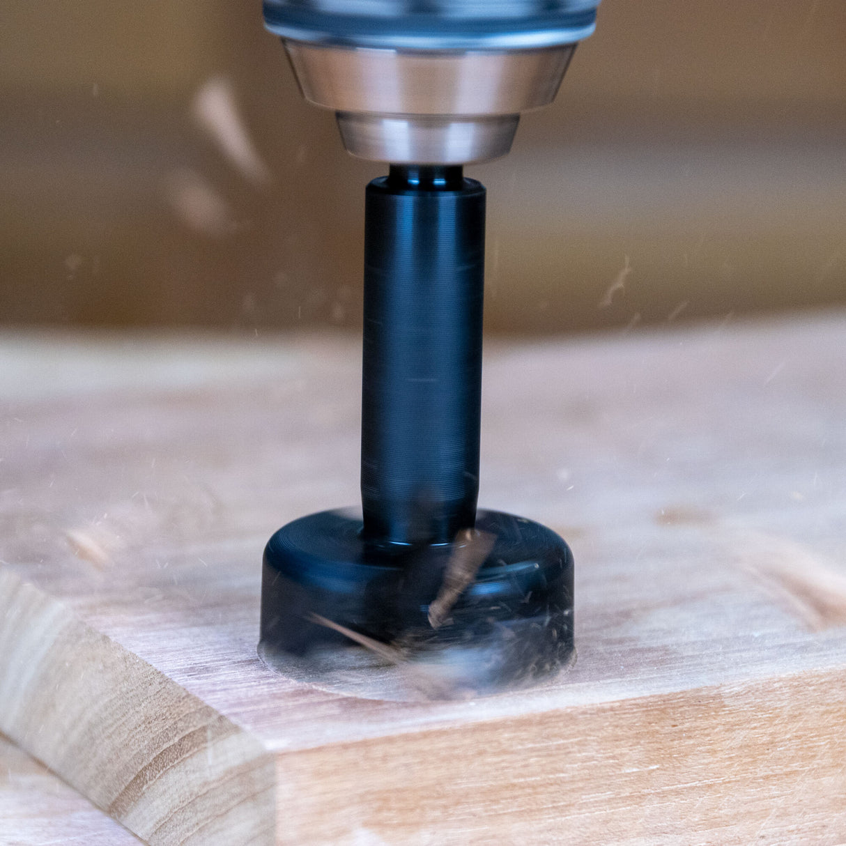 Router bit cutting into wood, showing precise woodworking tool in action