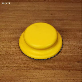 Yellow hand sanding pad for woodworking on a wood surface