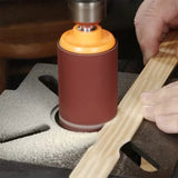 Oscillating spindle sander smoothing wooden board in woodworking workshop
