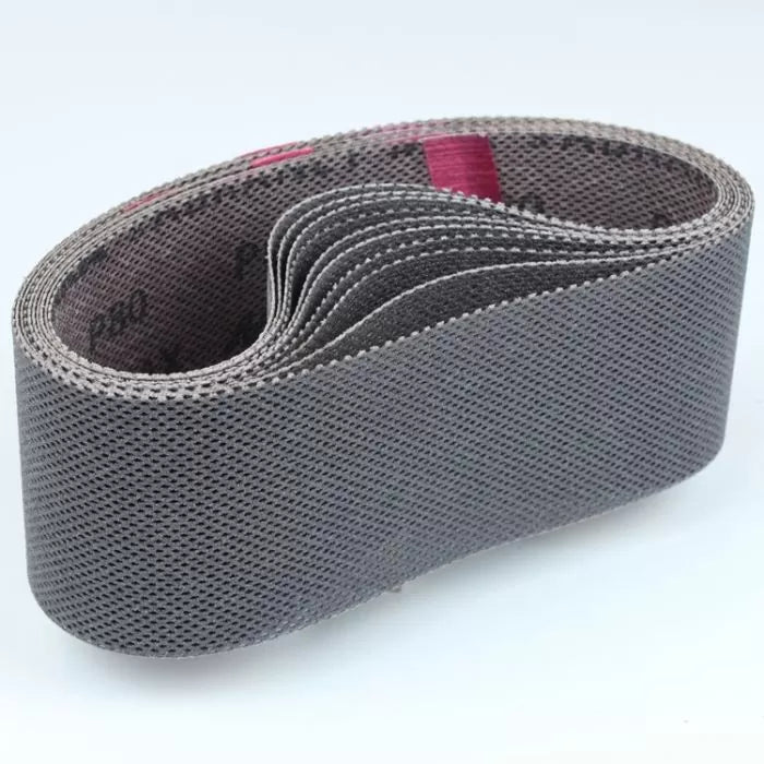 Abrasive sanding belt for woodworking, folded and textured, on a white background.