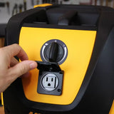 Hand opening dust extractor outlet on yellow woodworking tool in workshop setting