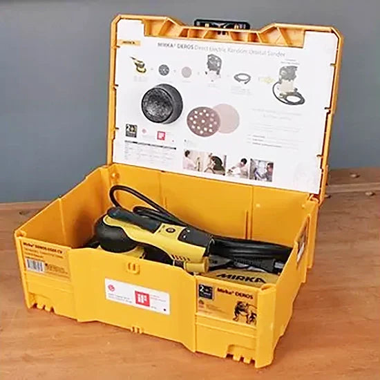 Electric random orbital sander in yellow case on wooden workbench ready for woodworking projects