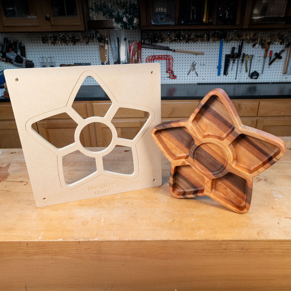 Star-shaped woodworking template and finished wood serving tray on workbench