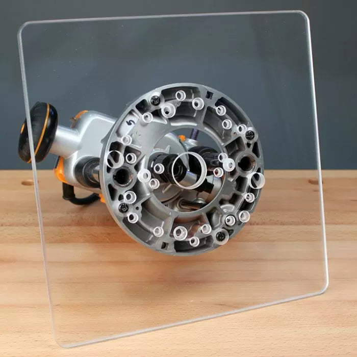 Clear acrylic router base plate attached to woodworking router on wooden workbench