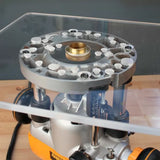 Close-up of a woodworking router base plate with brass guide bushing on a workbench