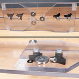 Clear acrylic router table jig with guide bearings and adjustment knobs on a workbench