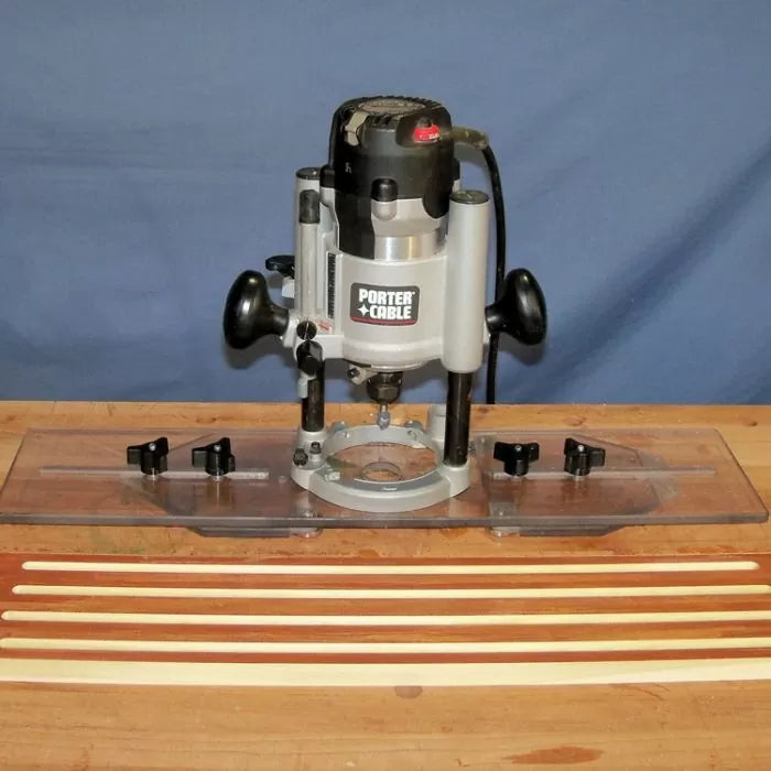 Woodworking router tool with clear base and multiple wood strips on a workbench