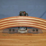 Router table jig setup on workbench with curved laminated wood piece for woodworking