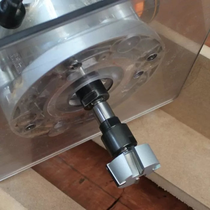 Close-up of a woodworking router with a straight router bit installed, ready for precision cutting.