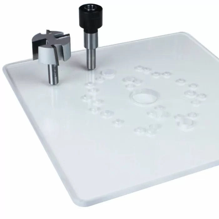 Router table insert plate with two woodworking router bits on white background