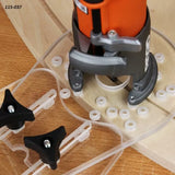 Woodworking router with clear acrylic jig and adjustment knobs on wood surface