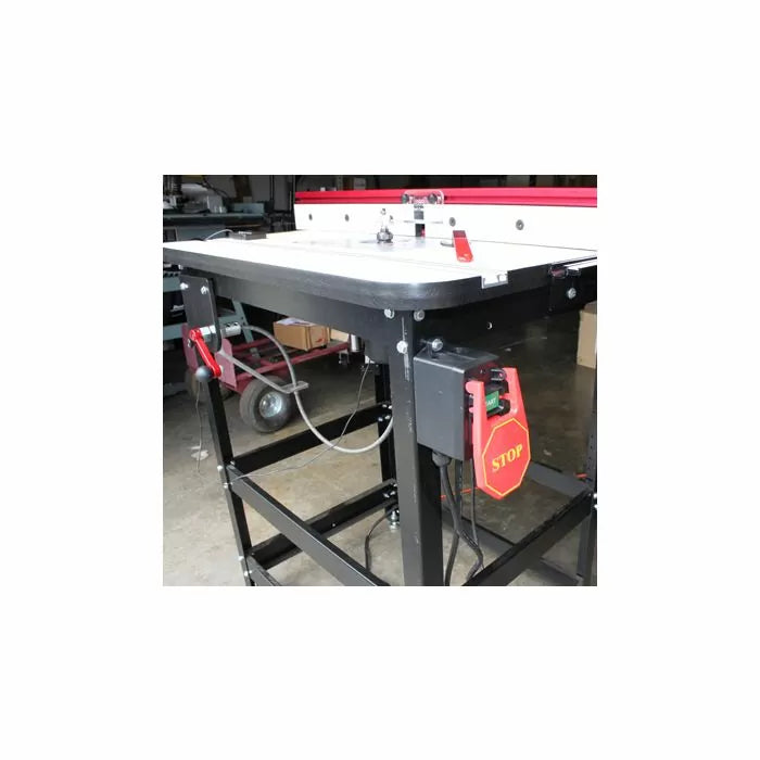 Woodworking router table with safety stop switch and sturdy metal frame in workshop
