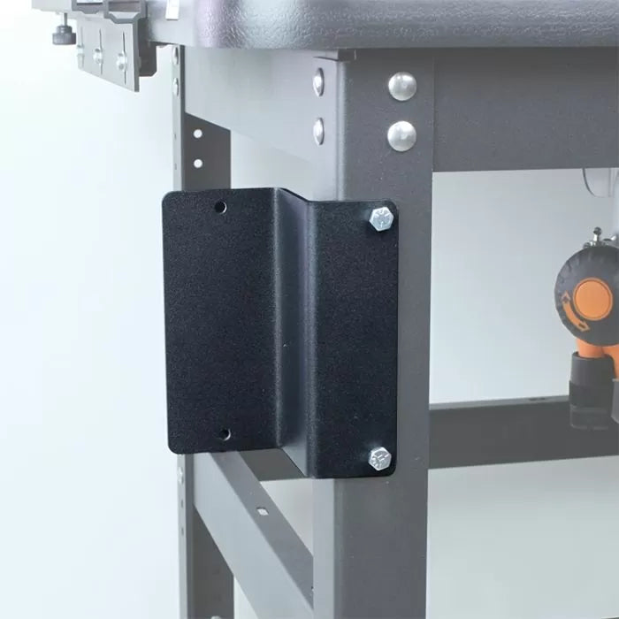 Steel mounting bracket attached to a workbench or router table leg with bolts