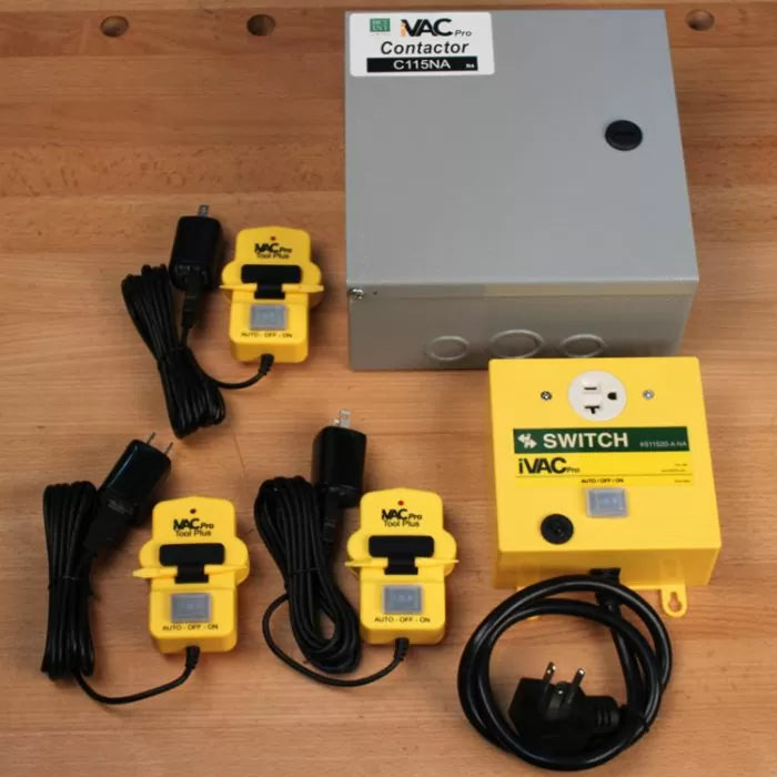 iVAC Pro switch and contactor automatic dust collection system with controllers on a wooden table