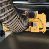Woodworking dust collection system with yellow automatic blast gate and flexible hose attached.