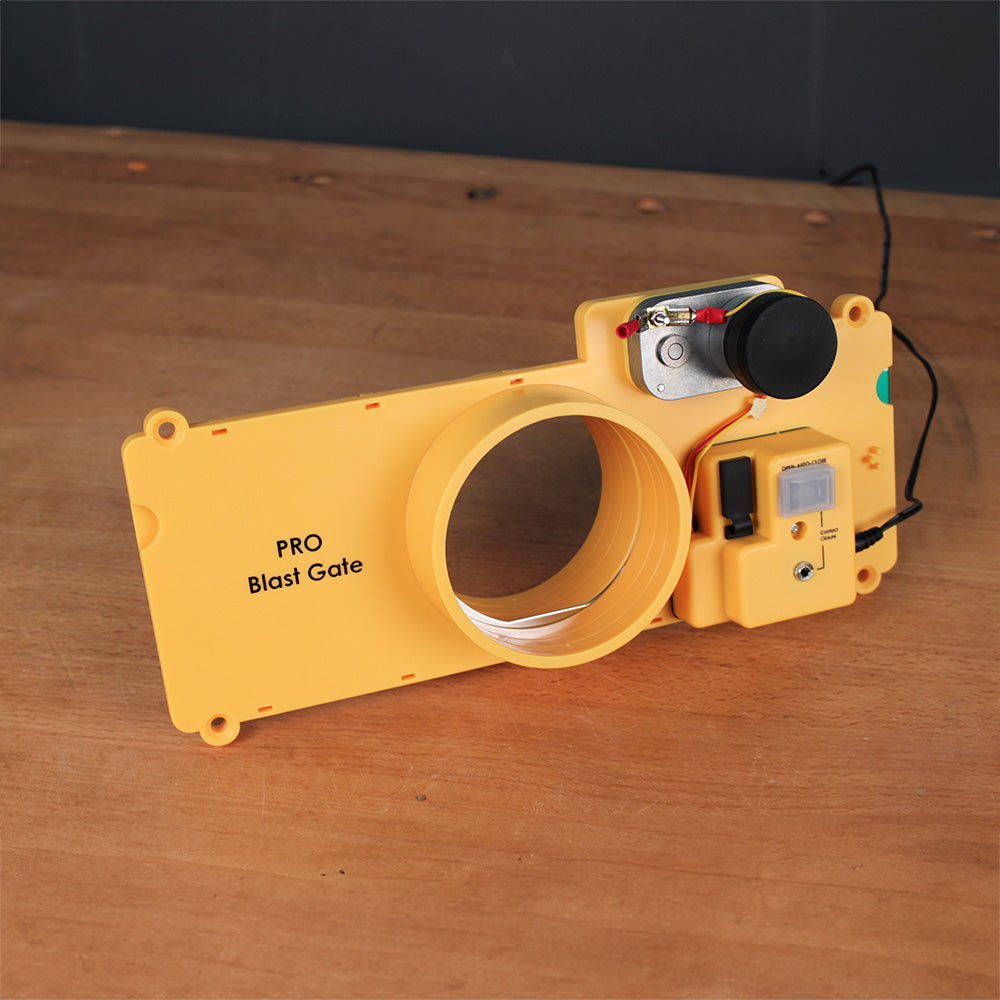 Yellow PRO blast gate for dust collection, with electronic switch on wood surface