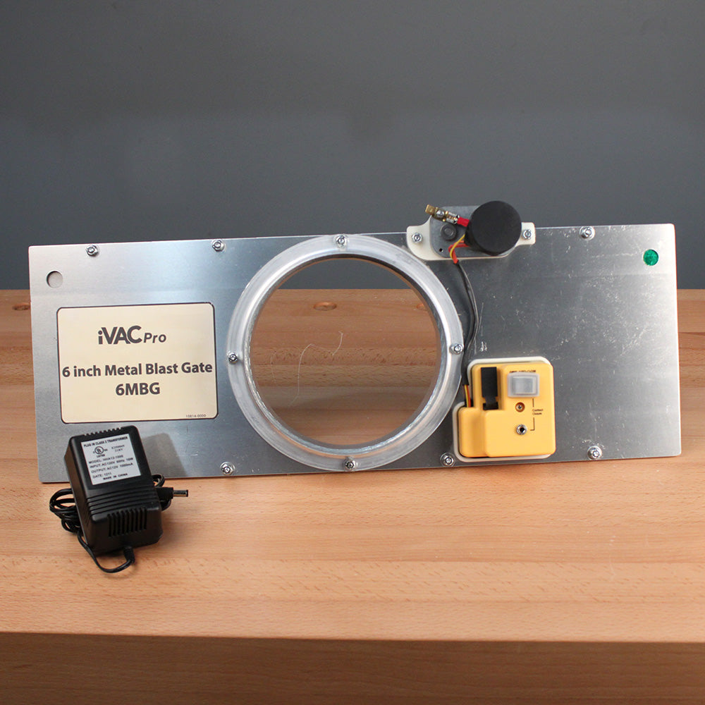 6 inch metal blast gate with electronic controller and power adapter on wooden surface