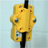 Yellow cable clamp mounted on wall for woodworking tool cord management