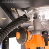 Dust hose connected to port on orange Triton router under router table