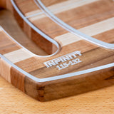 Closeup of acrylic cutting board template edge with engraved numbers on striped wood surface