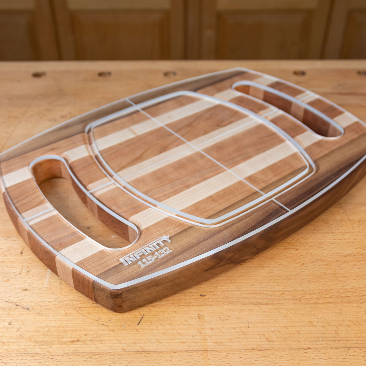 Acrylic cutting board template overlay on striped wood cutting board with handles
