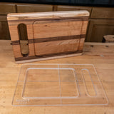 Clear acrylic cutting board template on workbench next to finished wood cutting board