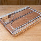 Acrylic cutting board template overlay on wood board, workshop background