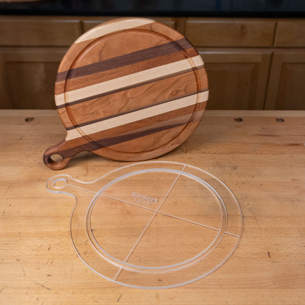 Clear acrylic cutting board template with circle handle on wood workbench