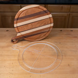 Clear acrylic cutting board template with circle handle on wood workbench