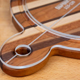 Acrylic cutting board template on striped wood cutting board, close-up detail