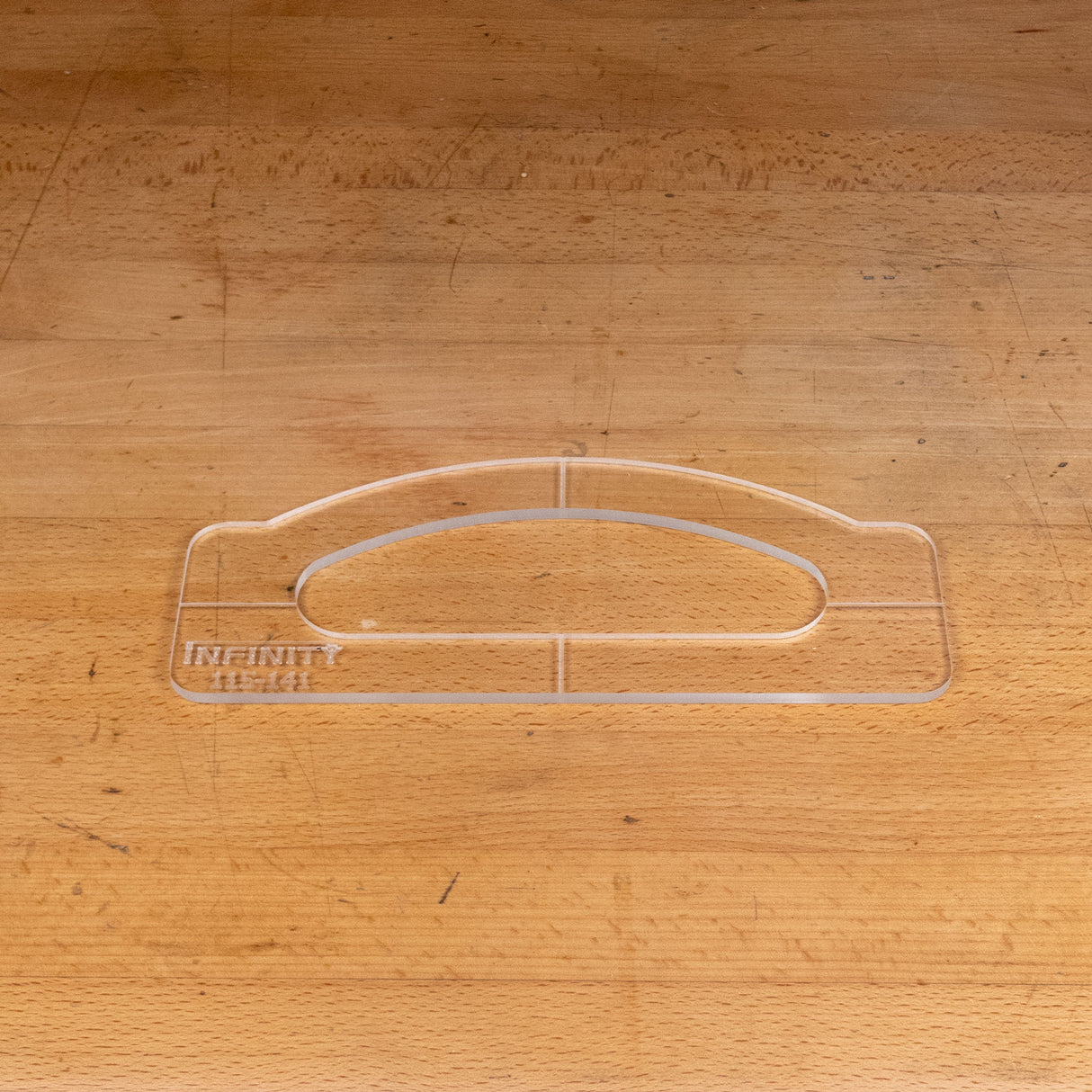 Clear acrylic handle template for woodworking on a wooden workbench