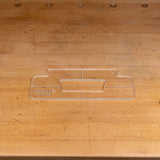 Clear acrylic handle template for woodworking, shown on a wooden workbench