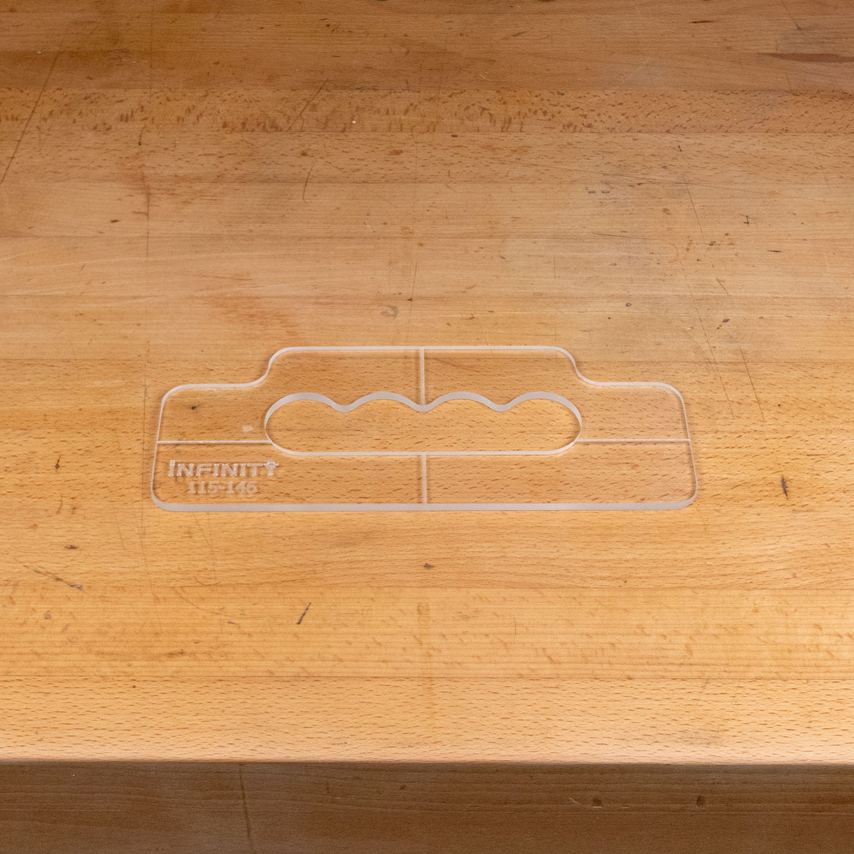Clear acrylic handle template for woodworking on a wooden workbench
