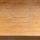 Clear acrylic handle template for woodworking on a wooden workbench