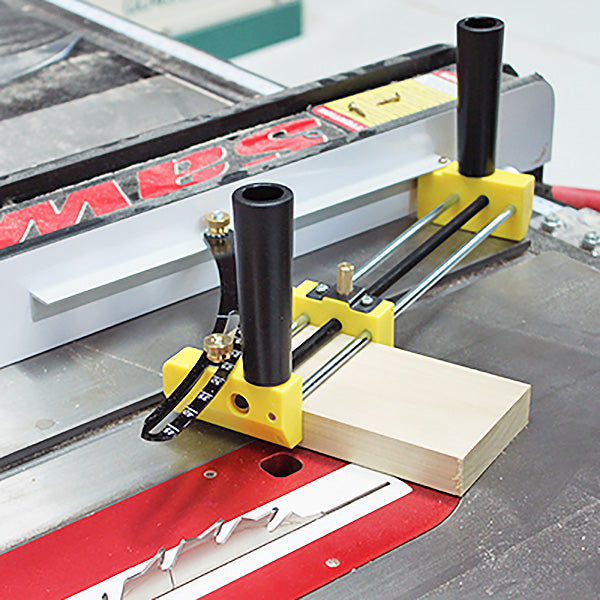 Table saw with yellow woodworking jig and fence guide, securing wood for precise cutting