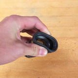 Hand holding woodworking dust collection fitting on a workbench