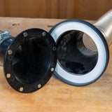 Magnetic dust collection hose coupling with black flanges on a wooden workbench
