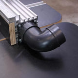 Router table fence with dust collection port and black plastic elbow attachment