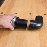 Quick connect dust collection hose fitting and elbow on a woodworking bench