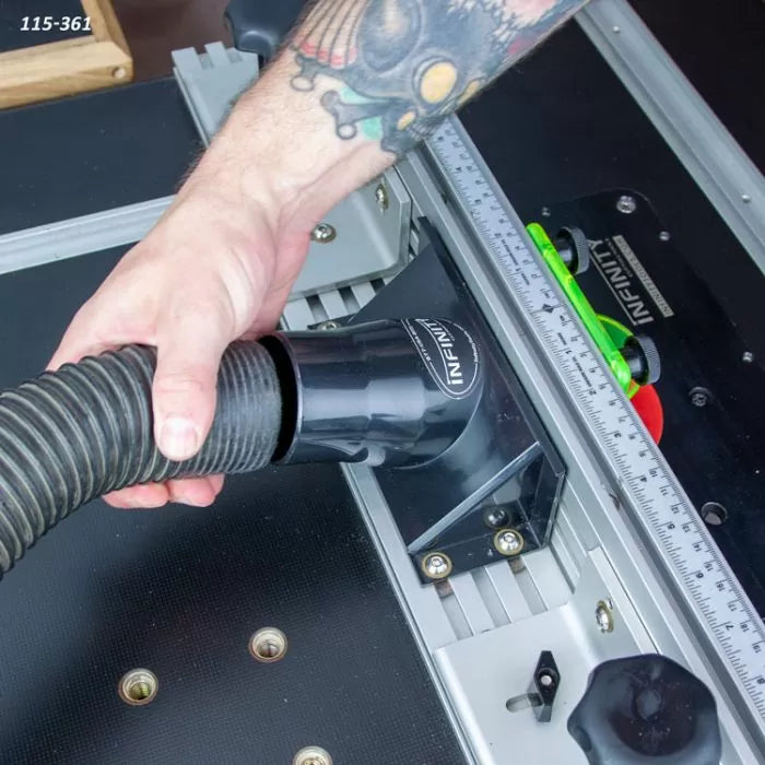 Hand attaching dust hose to router table fence for woodworking dust collection