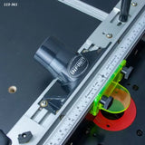 Router table fence with ruler, dust port, and safety guard for woodworking precision.
