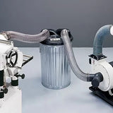 Woodworking dust collector separator with hoses connected to power tools and dust extractor.