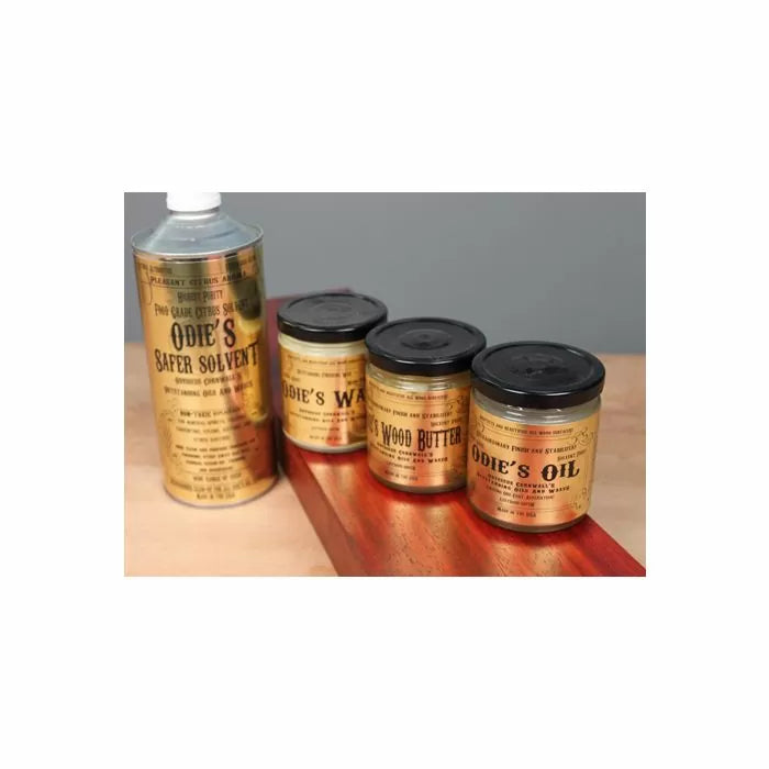 Wood finishing set with Odie's Safer Solvent, Wax, Wood Butter, Oil on a wood surface