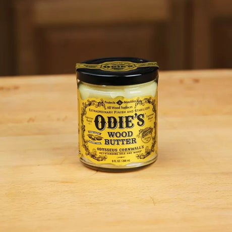 Odie's Wood Butter jar on wooden surface, natural wood finish and care product